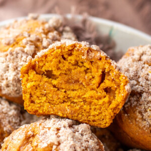 a half of a pumpkin muffin with streusel on top