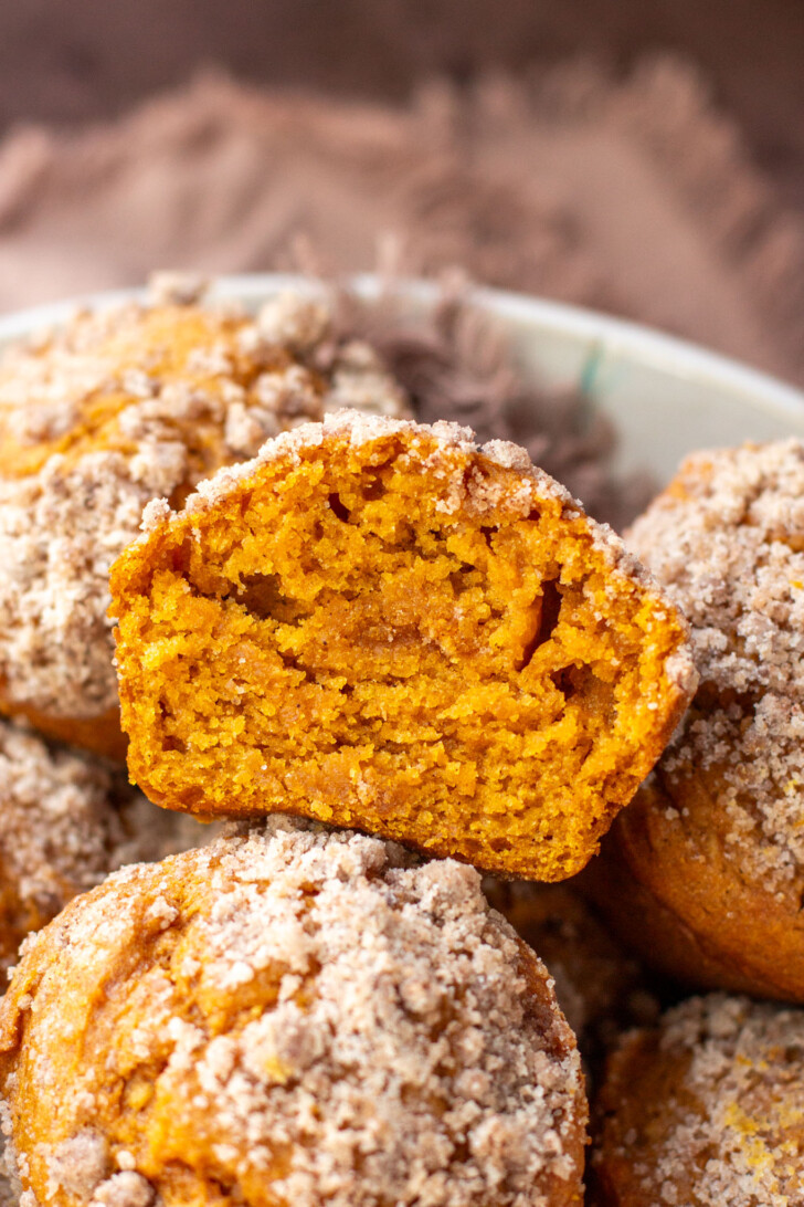 a half of a pumpkin muffin with streusel on top
