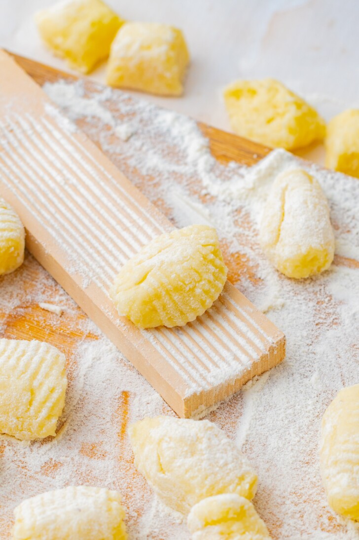 potato gnocchi on a gnocchi shaping board