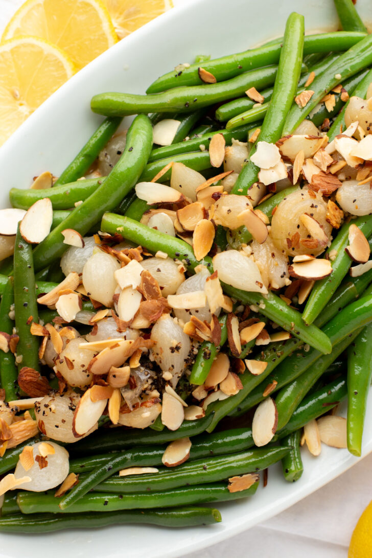 fresh green beans topped with onions and almonds