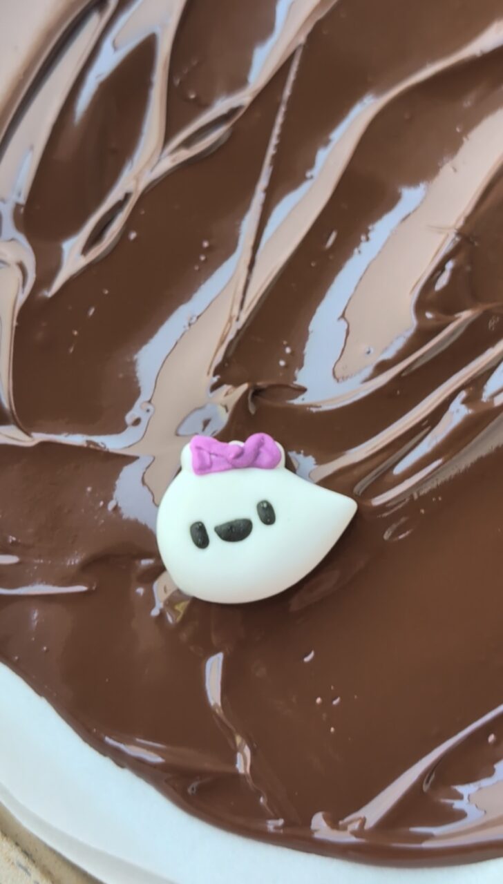 a candy ghost on melted chocolate